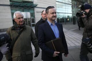 FILE -  Gay rights activist Gareth Lee, center, leaves Laganside court, Northern Ireland, Thursday March 26, 2015. A top European court said Thursday, Jan. 6, 2022 that it could not rule in a high-profile gay rights discrimination case centered on a request to decorate a cake with the words “Support Gay Marriage.” The Strasbourg-based European Court of Human Rights said the case was inadmissible because gay rights activist Gareth Lee had failed to “exhaust domestic remedies” in his case. (AP Photo/Peter Morrison, File)