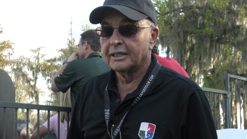 FILE - Tavistock founder Joe Lewis stands on the 18th green after the second day of the Tavistock Cup golf tournament in Windermere, Fla., March 15, 2011. British billionaire and Tottenham soccer team owner Joe Lewis has been indicted in the U.S. on charges of slipping confidential business information to people ranging from his romantic partners to his private pilots, prosecutors said Tuesday, July 25, 2023. (AP Photo/Phelan M. Ebenhack, File)
