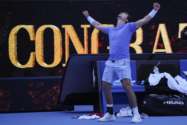 J.J. Wolf of the U.S. celebrates after defeating compatriot Michael Mmoh in their third round match at the Australian Open tennis championship in Melbourne, Australia, Saturday, Jan. 21, 2023. (AP Photo/Dita Alangkara)