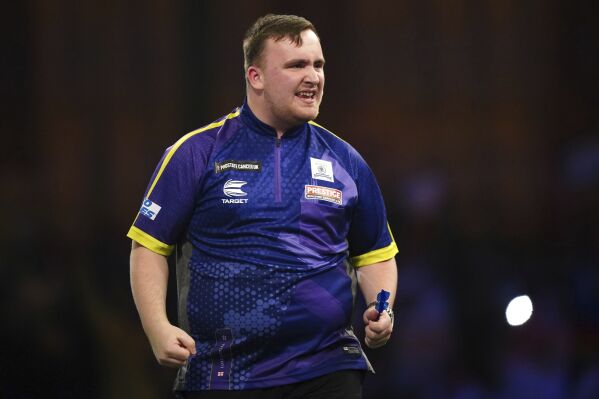 England's Luke Littler reacts during his match against England's Andrew Gilding on day seven of the World Darts Championship at Alexandra Palace, London, Thursday, Dec. 21, 2023. (Zac Goodwin/PA via AP)