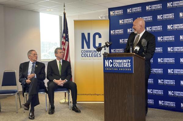 Wilkes Community College President Jeff Cox, right, speaks as Gov. Roy Cooper, center, and State Board of Community Colleges Chair Burr Sullivan listen during a news conference at the North Carolina Community College System offices in Raleigh, N.C., Monday, April 24, 2023. Cox spoke three days after the State Board of Community Colleges approved him to become the next president of the 58-college system. (AP Photo/Gary D. Robertson)