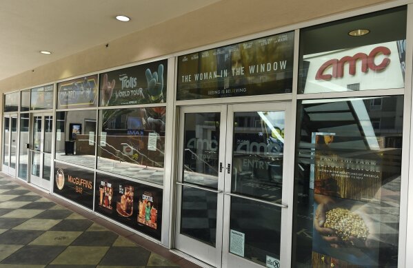 The front entrance to the currently closed AMC Burbank 16 movie theaters complex is pictured, Wednesday, April 29, 2020, in Burbank, Calif. Universal Pictures is calling the “Trolls World Tour” digital release a success and suggests it may be the beginning of a sea change in how movies are released. Theater owners strenuously disagree. AMC Theaters, the largest chain in the United States, is signaling an all-out war, saying it will refuse to play Universal movies. (AP Photo/Chris Pizzello)