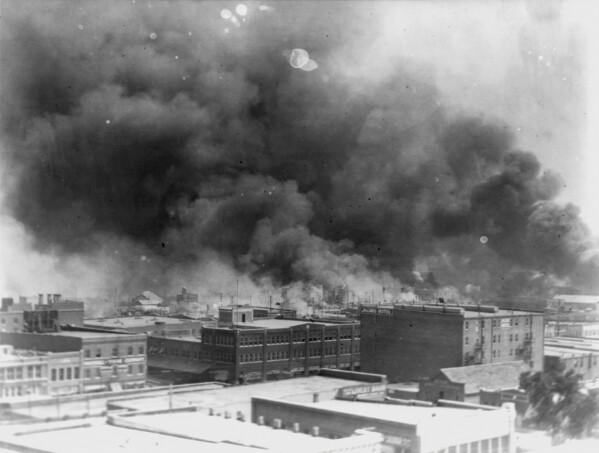 In this 1921 image provided by the Library of Congress, smoke billows over Tulsa, Okla. An Oklahoma judge has thrown out a lawsuit seeking reparations for the 1921 Tulsa Race Massacre, dashing an effort to obtain some measure of legal justice by survivors of the deadly racist rampage. (Alvin C. Krupnick Co./Library of Congress via AP)