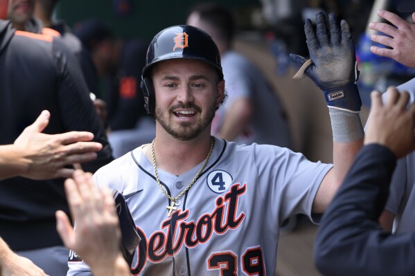 Detroit Tigers' Zach McKinstry is congratulated after scoring on a wild pitch during the third inning of a baseball game against the Kansas City Royals in Kansas City, Mo., Sunday, June 1, 2025. (AP Photo/Reed Hoffmann)