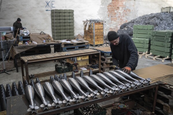 A worker assembles mortar shells at a factory in Ukraine, on Wednesday, January 31, 2024. (AP Photo/Evgeniy Maloletka)