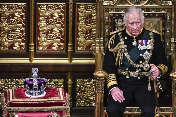 Britain's Prince Charles sits by the The Imperial State Crown in the House of Lords Chamber, during the State Opening of Parliament, in the Houses of Parliament, in London, Tuesday, May 10, 2022. Britain’s Conservative government made sweeping promises to cut crime, improve health care and revive the pandemic-scarred economy as it laid the laws it plans in the next year in a tradition-steeped ceremony known as the Queen’s Speech -- but without a key player, Queen Elizabeth II, absent for the first time in six decades. The 96-year-old monarch pulled out of the ceremonial State Opening of Parliament because of what Buckingham Palace calls “episodic mobility issues.” Her son and heir, Prince Charles, stood in, rattling through a short speech laying out 38 bills the government plans to pass. (Ben Stansall/Pool Photo via AP)