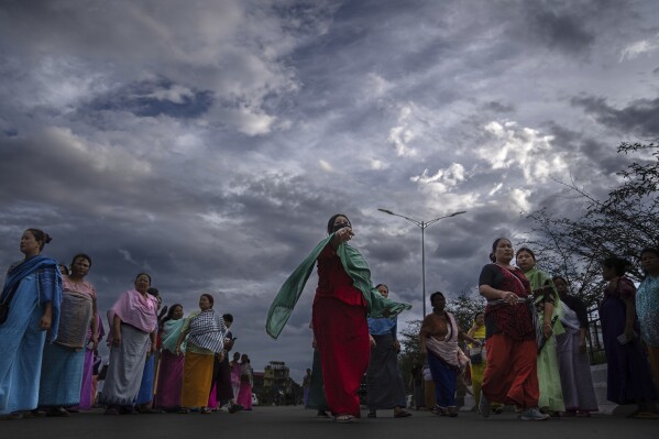 Members of Meira Paibis, powerful vigilante group of Hindu majority Meitei women, block traffic as they check vehicles for the presence of members from rival Christian tribal Kuki community, in Imphal, capital of the northeastern Indian state of Manipur, Monday, June 19, 2023. Manipur is caught in a deadly conflict between the two ethnic communities that have armed themselves and launched brutal attacks against one another. This is an unseen war, barely visible on the country’s countless TV news channels and newspapers, a conflict hidden behind the blanket shutdown of the internet. (AP Photo/Altaf Qadri)