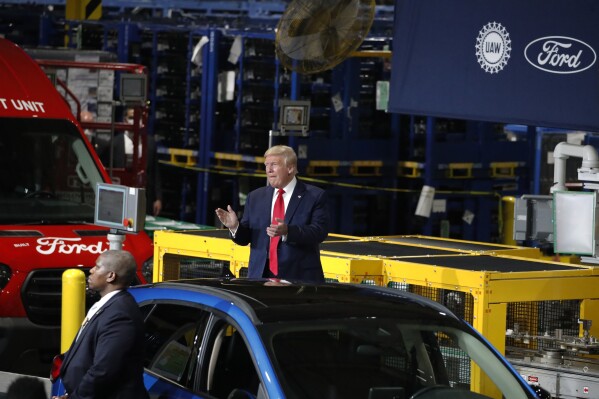 FILE - President Donald Trump claps as he walks to the podium to speak at Ford's Rawsonville Components Plant that has been converted to making personal protection and medical equipment, Thursday, May 21, 2020, in Ypsilanti, Mich. Former President Donald Trump will skip the second GOP presidential debate next week to travel to Detroit as the auto worker strike enters its second week. Trump is planning to speak with union members and will look to blunt criticisms from a United Auto Workers union leadership that has said a second Trump term would be a “disaster.” (AP Photo/Alex Brandon, File)