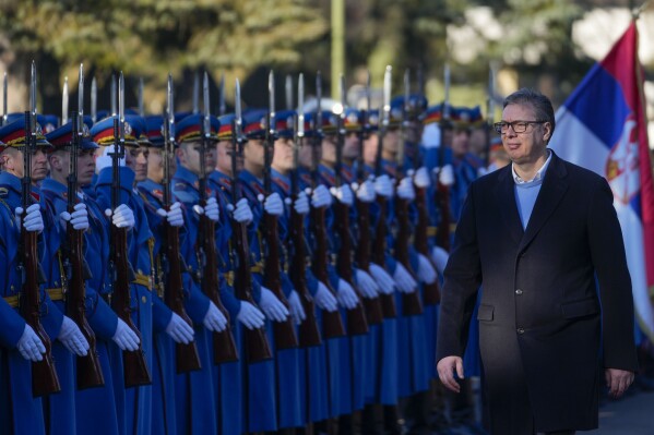 Serbia's President Aleksandar Vucic reviews the honor guard during a welcoming ceremony at the army barracks in Belgrade, Serbia, Tuesday, Jan. 30, 2024. Serbia should reintroduce compulsory military service, the Balkan country's president said Tuesday, citing tensions in the Balkans and elsewhere in Europe. After a meeting with top army commanders, President Aleksandar Vucic said that they gave him 
