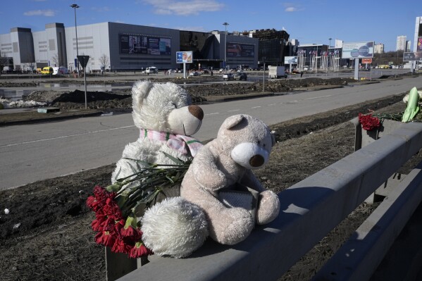 Toys and flowers lie in front of the Crocus City Hall on the western outskirts of Moscow, Russia, Wednesday, March 27, 2024. (AP Photo/Alexander Zemlianichenko)