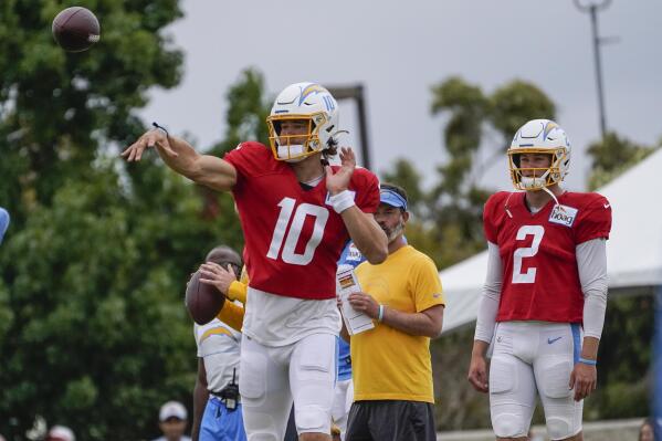 Los Angeles Chargers quarterbacks, Justin Herbert, left, and Easton Stick practice as the Chargers and the San Francisco 49ers hold a joint NFL football team practice in Costa Mesa, Calif., Friday, Aug. 20, 2021. (AP Photo/Damian Dovarganes)