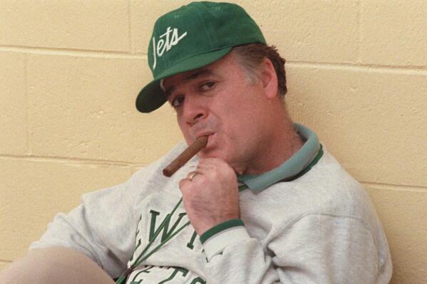 FILE - in this Dec. 31, 1986 file photo, New York Jets coach Joe Walton smokes a cigar during an interview at Hofstra University in West Hempstead, N.Y. Walton, the former New York Jets coach who built Robert Morris University’s football program from the ground up, died Sunday, Aug. 15, 2021. He was 85. (AP Photo/W. Funches)