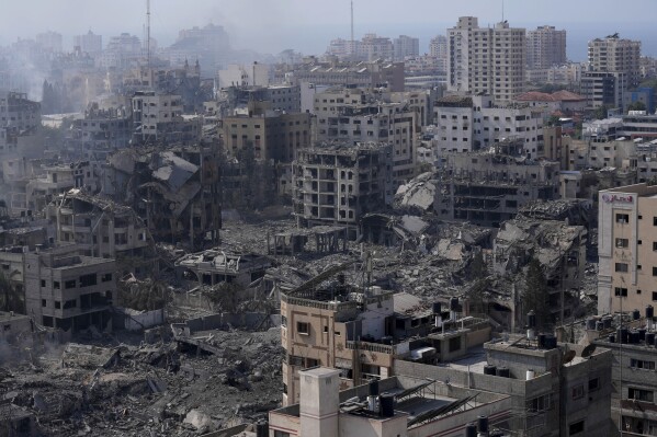 Destruction from Israeli aerial bombardment is seen in Gaza City, Wednesday, Oct. 11, 2023. (AP Photo/Adel Hana)