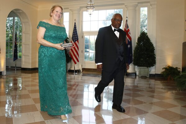 FILE - In this Sept. 20, 2019, file photo, Supreme Court Associate Justice Clarence Thomas, right, and wife Virginia "Ginni" Thomas arrive for a State Dinner with Australian Prime Minister Scott Morrison and President Donald Trump at the White House in Washington. Ginni Thomas is using her Facebook page to amplify unsubstantiated claims of corruption by Joe Biden. She is a longtime conservative activist who asked her more than 10,000 followers Oct. 26, 2020, to consider sharing a link focused on alleged corruption by Biden and his son, Hunter, as well as claims that social media companies are censoring reports about the Bidens. (AP Photo/Patrick Semansky, File)