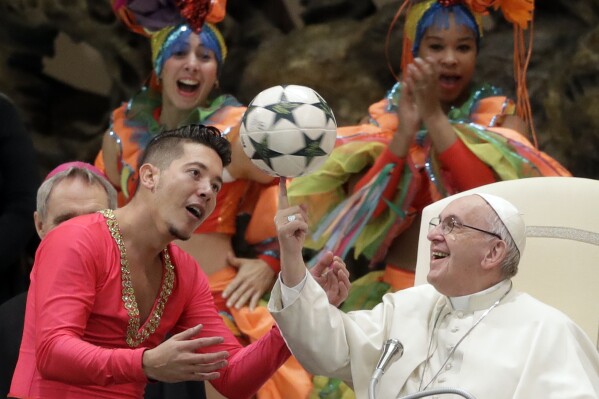 Pope Francis twirls a soccer ball he was presented by a member of the Circus of Cuba, during his weekly general audience in the Pope Paul VI hall, at the Vatican, Wednesday, Jan. 2, 2019. (AP Photo/Andrew Medichini, file)