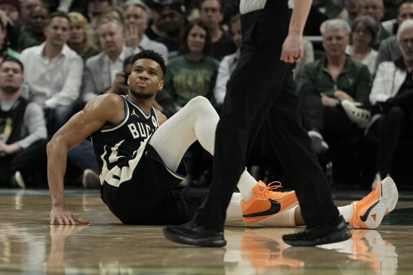 Milwaukee Bucks' Giannis Antetokounmpo sits on the court during the second half of an NBA basketball game against the Boston Celtics Tuesday, April 9, 2024, in Milwaukee. Giannis Antetokounmpo left the game. The Bucks won 104-91. (AP Photo/Morry Gash)