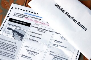 FILE - This May 26, 2020 file photo shows an Official Democratic General Primary mail-in ballot and secrecy envelope, for the Pennsylvania primary in Pittsburgh. Democrats are launching a digital ad targeting Pennsylvanians voting by mail to explain how to correctly fill out and return the ballots, hoping to avert worried predictions that 100,000 votes or more could be invalidated because the ballots aren't put in the proper envelope. (AP Photo/Gene J. Puskar, File)