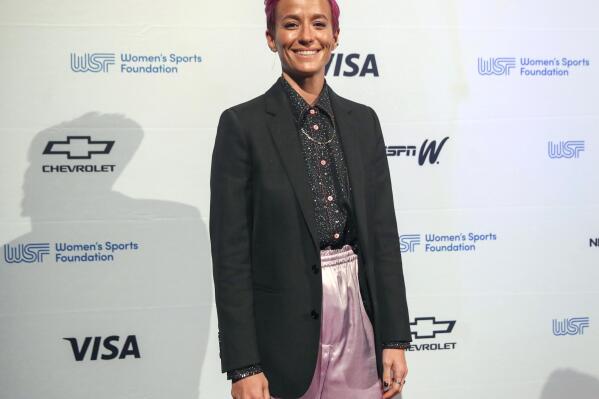 FILE - Soccer player Megan Rapinoe poses for photos on the red carpet of the Women's Sports Foundation's 40th annual Salute to Women in Sports in New York on Oct. 16, 2019. Rapinoe has selected #MeToo founder Tarana Burke's memoir, “Unbound,” for her new book club. (AP Photo/Mary Altaffer, File)