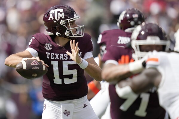 Texas A&M quarterback Conner Weigman (15) throws down field against Auburn during the first quarter of an NCAA college football game Saturday, Sept. 23, 2023, in College Station, Texas. (AP Photo/Sam Craft)