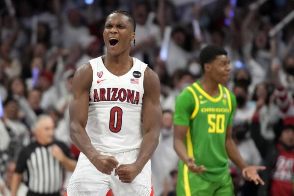 Arizona guard Bennedict Mathurin (0) reacts after scoring against Oregon during the first half of an NCAA college basketball game, Saturday, Feb. 19, 2022, in Tucson, Ariz. (AP Photo/Rick Scuteri)