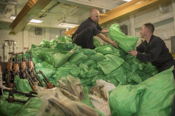 
              In this photo made available Thursday, Aug. 30, 2018, a team from the guided-missile destroyer USS Jason Dunham inspects weapons seized from vessels in the Gulf of Aden. A U.S. military video released early Friday, Aug. 31, 2018, purported to show small ships in the Gulf of Aden smuggling weapons amid the ongoing war in Yemen, with officials saying they seized over 1,000 arms from the vessels. (U.S. Navy via AP)
            
