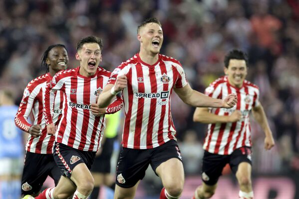 Sunderland's Daniel Ballard, center, and teammates celebrate after the final whistle against Coventry City in a Sky Bet Championship play-off semifinal, second leg soccer match at the Stadium of Light, Tuesday May 13, 2025, in Sunderland, England. (Steve Welsh/PA via AP)