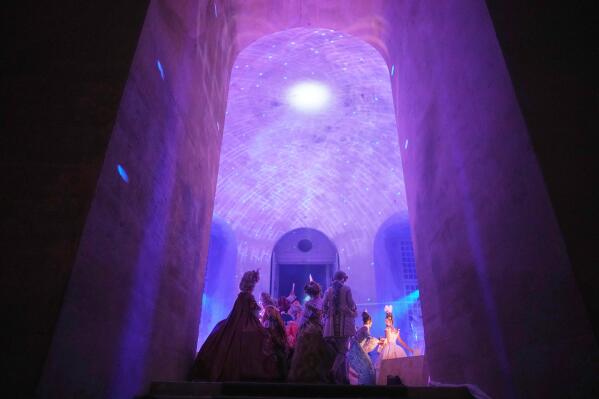 Costumed guests dance at the Great Masked Ball in the Orangerie of the Versailles castle, outside Paris, Sunday, June 22, 2025. (AP Photo/Christophe Ena)