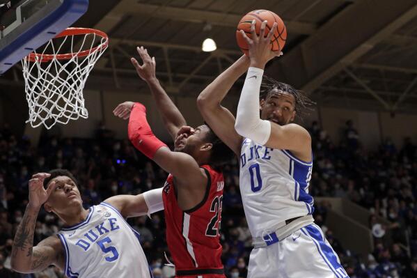 Duke forward Paolo Banchero (5) and forward Wendell Moore Jr. (0) battle Gardner-Webb guard Anthony Selden (23) for a rebound during the first half of an NCAA college basketball game Tuesday, Nov. 16, 2021, in Durham, N.C. (AP Photo/Chris Seward)