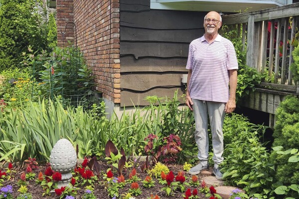Jeff Kellert stands in his garden at his home in Albany, N.Y. on June 20, 2024. Kellert began volunteering as a tutor and helped with monthly dinners at his synagogue. The experience keeps him active, but just as important, he said, it has led to new friendships and a sense of purpose he never expected in retirement. (Robert Piechota via ĢӰԺ)