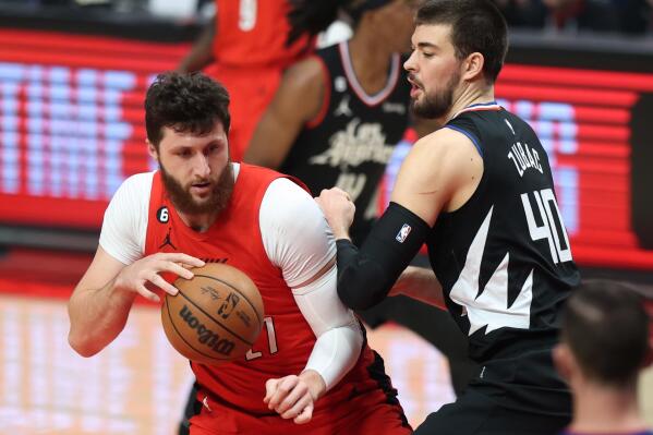 Portland Trail Blazers center Jusuf Nurkic, left, makes a move under the basket against Los Angeles Clippers center Ivica Zubac, right, during the first half of an NBA basketball game in Portland, Ore., Tuesday, Nov. 29, 2022. (AP Photo/Steve Dipaola)