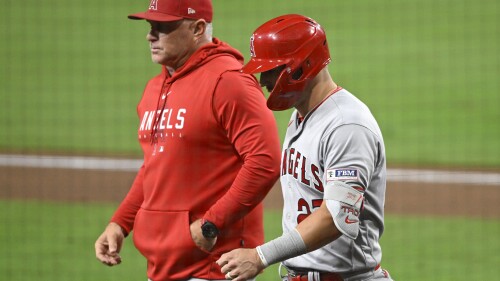 Los Angeles Angels' Mike Trout (27) walks next to manager Phil Nevin as he leaves the game during the eighth inning of a baseball game against the San Diego Padres Monday, July 3, 2023, in San Diego. (AP Photo/Denis Poroy)