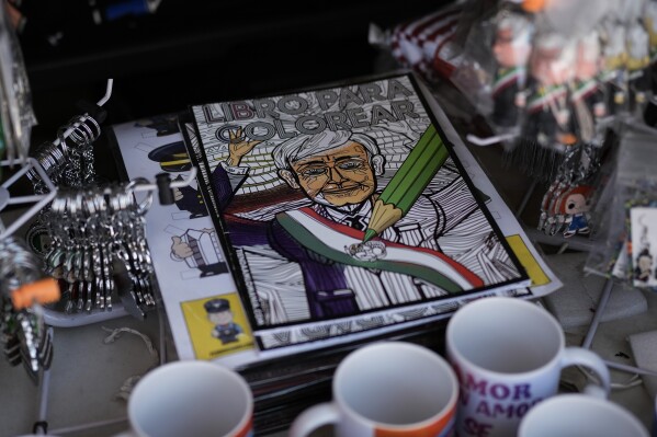 A coloring book featuring Mexican President Andrés Manuel López Obrador is for sale outside the presidential palace in Mexico City, Thursday, March 14, 2024. Despite not being eligible to run for reelection in the upcoming June 2 presidential vote, López Obrador looms larger than any of the candidates competing for the helm of Mexico’s government. (AP Photo/Eduardo Verdugo)