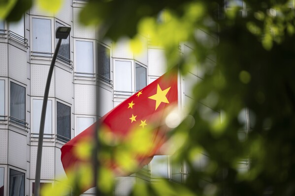 A country's flag flies in front of the embassy of China in Berlin, Germany, Monday, April 22, 2024. Three people suspected of spying for China and facilitating the transfer of information on technology with potential military uses were arrested in Germany on Monday. The homes and offices of the suspects, who were arrested in Duesseldorf and in Bad Homburg, near Frankfurt, were searched. (Hannes P. Albert/dpa via AP)