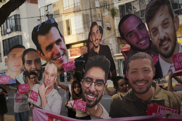Relatives and supporters of Israeli hostages held by Hamas in Gaza display photos of the captives during a protest demanding their release. in Tel Aviv, Israel, on Saturday, June 21, 2025. (AP Photo/Ohad Zwigenberg)