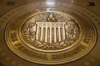 FILE- The seal of the Board of Governors of the United States Federal Reserve System is displayed in the ground at the Marriner S. Eccles Federal Reserve Board Building in Washington, Feb. 5, 2018. Since Federal Reserve officials last met in July, the economy has moved in the direction they hoped to see: Inflation continues to ease, if more slowly than before, while growth remains solid and the job market cools. (AP Photo/Andrew Harnik, File)