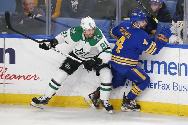 Dallas Stars center Tyler Seguin (91) and Buffalo Sabres defenseman Will Butcher (4) collide during the first period of an NHL hockey game, Thursday, Jan. 20, 2022, in Buffalo, N.Y. (AP Photo/Jeffrey T. Barnes)