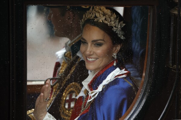 FILE - Kate, Princess of Wales and Prince William travel in a coach following the coronation ceremony of Britain's King Charles III in London, Saturday, May 6, 2023. (AP Photo/David Cliff, File)