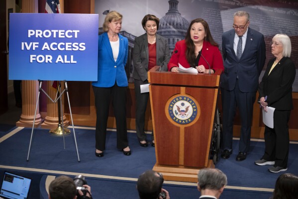 Sen. Tammy Duckworth, D-Ill., center, speaks about a bill to establish federal protections for IVF as, from left, Sen. Tammy Baldwin, D-Wis., Sen. Amy Klobuchar, D-Minn., Senate Majority Leader Chuck Schumer of N.Y., and Sen. Patty Murray, D-Wash., listen during a press event on Capitol Hill, Tuesday, Feb. 27, 2024, in Washington. (AP Photo/Mark Schiefelbein)