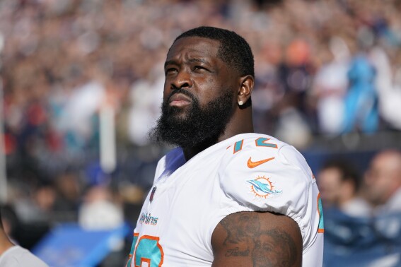FILE - Miami Dolphins offensive tackle Terron Armstead looks at the scoreboard during an NFL football game against the Chicago Bears, Nov. 6, 2022, in Chicago. Armstead, Miami Dolphins' veteran left tackle, will open training camp on the physically unable to perform list along with second-year tight end Tanner Conner and offensive tackle Isaiah Wynn. The Dolphins announced the news on Tuesday, July 25, 2023, on the day veterans reported for training camp. (AP Photo/Charles Rex Arbogast, File)