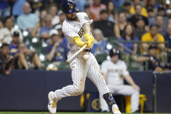 Milwaukee Brewers' Blake Perkins hits a winning single against the Pittsburgh Pirates during the 10th inning of a baseball game Saturday, Aug 5, 2023, in Milwaukee. (AP Photo/Jeffrey Phelps)