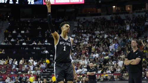 San Antonio Spurs' Victor Wembanyama celebrates after making a 3-point shot against the Portland Trail Blazers during the second half of an NBA summer league basketball game Sunday, July 9, 2023, in Las Vegas. (AP Photo/John Locher)