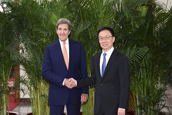 In this photo released by Xinhua News Agency, U.S. Special Presidential Envoy for Climate John Kerry, left, shakes hands with Chinese Vice President Han Zheng during a meeting in Beijing, Wednesday, July 19, 2023. China is willing to work with Washington on reducing global warming as long as its political demands are met, the country's vice president told U.S. climate envoy John Kerry on Wednesday. (Zhang Ling/Xinhua via AP)