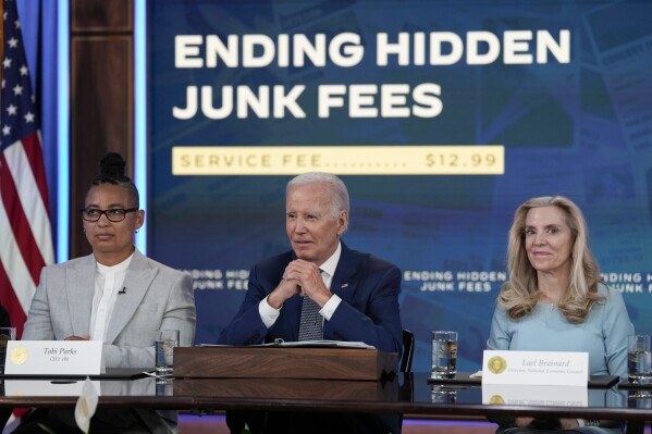 President Joe Biden speaks in the South Court Auditorium on the White House complex in Washington, Thursday, June 15, 2023, to highlight his administration's push to end so-called junk fees that surprise customers. Lael Brainard, Assistant to the President and Director of the National Economic Council, right, and Tobi Parks, CEO xBk, left, listen. (AP Photo/Susan Walsh)