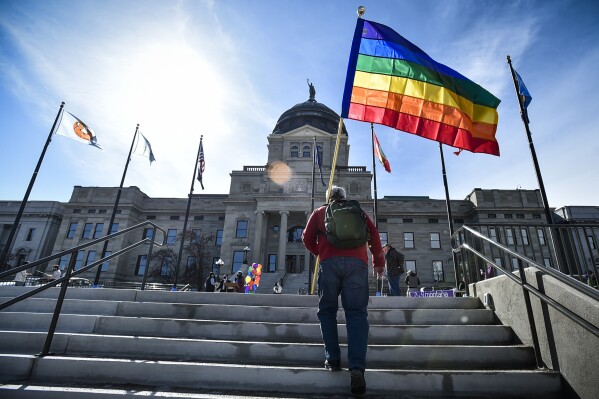 FILE - Demonstrators gather on the steps of the Montana Capitol protesting anti-LGBTQ+ legislation, March 15, 2021, in Helena, Mont. On Monday, Dec. 18, 2023, the ACLU of Montana filed a lawsuit over a law that defines the word "sex" in state law as being only either male or female, based on a person's biology at birth. The plaintiffs argue the law denies legal recognition and protections to transgender, two spirit and intersex individuals. (Thom Bridge/Independent Record via AP, File)