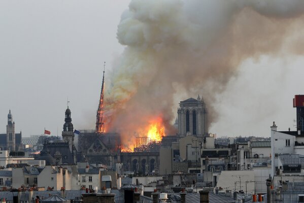 
              FILE. In this April 15, 2019 file photo, flames rise from Notre Dame cathedral as it burns in Paris. Notre Dame Cathedral's melted roof has left astronomically high lead levels in the plaza outside and adjacent roads. Paris police say lead levels from the roof were found to be between 10 and 20 grams per kilogram of ground — between 32 and 65 times the recommended limit by French health authorities of 0.3 grams per kilogram. (AP Photo/Thibault Camus)
            