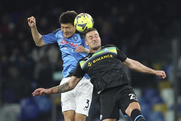FILE - Napoli's Kim Min-Jae, left, battles for a head ball with Lazio's Elseid Hysaj during the Serie A soccer match between Napoli and Lazio, at the Diego Armando Maradona stadium in Naples, Italy, on March 3, 2023. Bayern Munich has signed South Korean defender Kim Min-jae from Italian champion Napoli for a reported fee of 50 million euros ($55 million). The Bavarian powerhouse said Tuesday that the 26-year-old Kim signed a five-year deal through June 2028 and will wear the No. 3. (Alessandro Garofalo/LaPresse via AP, File)