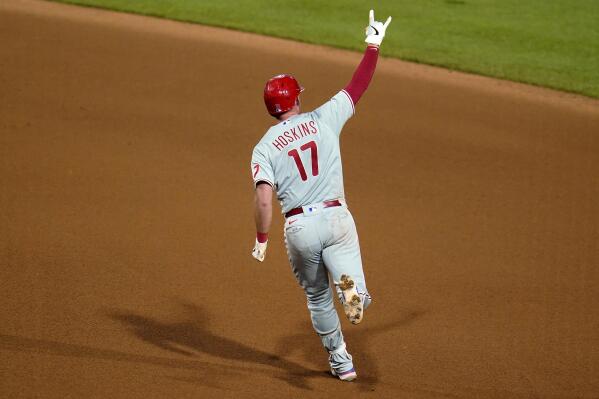 Philadelphia Phillies' Rhys Hoskins celebrates as he runs the bases on a two-run home run off Pittsburgh Pirates relief pitcher Duane Underwood Jr. during the 10th inning of a baseball game in Pittsburgh, Friday, July 29, 2022. The Phillies won 4-2. (AP Photo/Gene J. Puskar)