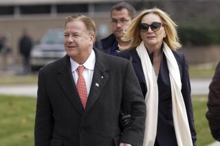FILE - In this Nov. 16, 2021, file photo, Mark McCloskey, a Republican candidate for U.S. Senate in Missouri, and his wife, Patricia McCloskey, walk outside the Kenosha County Courthouse, in Kenosha, Wis. The Missouri Supreme Court denied a request by U.S. Senate candidate Mark McCloskey and his wife to give free legal advice to a conservative activist group as a condition of their probation, but McCloskey said Thursday, May 19, 2022 he'll try to find another right-wing organization to represent. (AP Photo/Paul Sancya, File)