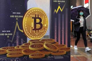 FILE - An advertisement for Bitcoin cryptocurrency is displayed on a street in Hong Kong, on Feb. 17, 2022.  Bitcoin slumped to a two-year low, Wednesday, Nov. 9, and other digital assets sold off following the sudden collapse of crypto exchange FTX Trading, which has been forced to sell itself to larger rival Binance. (AP Photo/Kin Cheung, File)