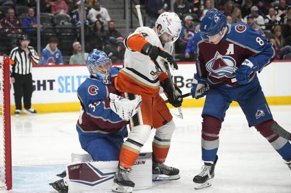 Colorado Avalanche goaltender Pavel Francouz, left, makes a glove save as Anaheim Ducks center Adam Henrique is cleared by Avalanche defenseman Cale Makar during the second period of an NHL hockey game Thursday, Jan. 26, 2023, in Denver. (AP Photo/David Zalubowski)